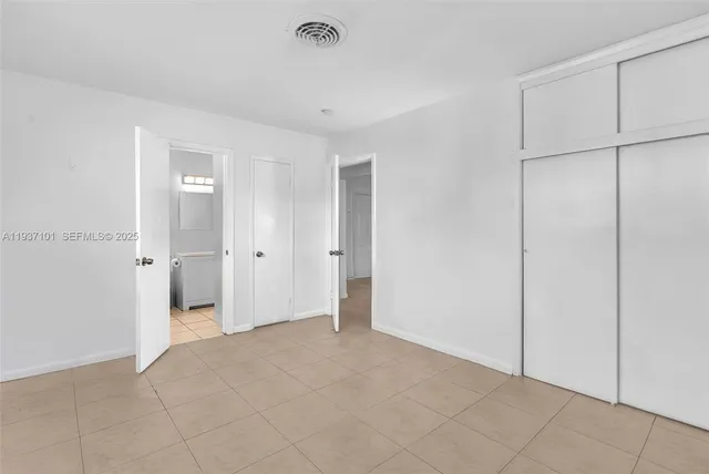 a view of a patio with table and chairs and potted plants