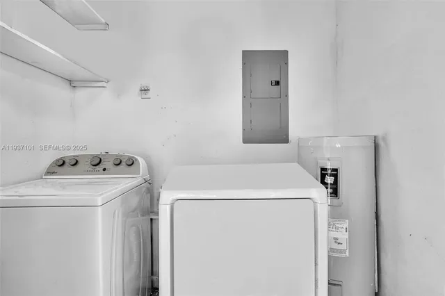 a kitchen with granite countertop a refrigerator and a stove top oven