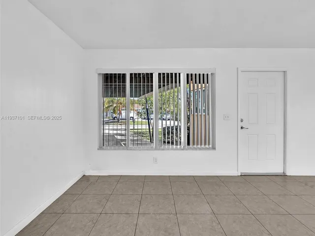 a view of residential houses with outdoor space and street view