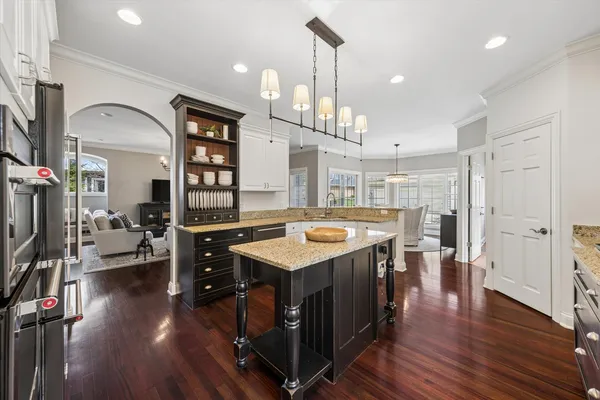 a kitchen with a counter space appliances and wooden floor