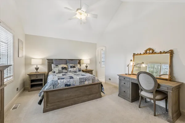 a bathroom with a granite countertop sink a toilet and a mirror