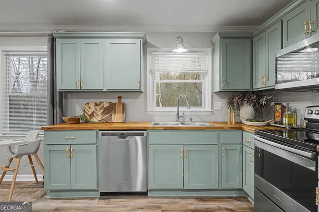 a kitchen with granite countertop a sink window and cabinets