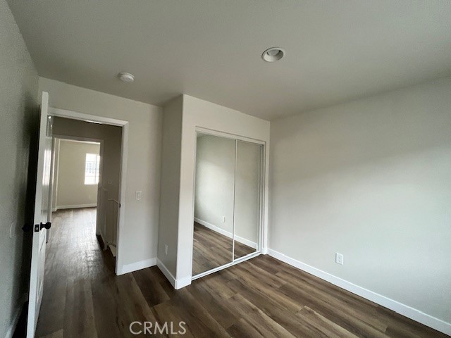 1004 South Riverside Avenue, Unit B2 Rialto, CA 92376 - Photo 12 of 14 a view of a hallway with wooden floor and closet
