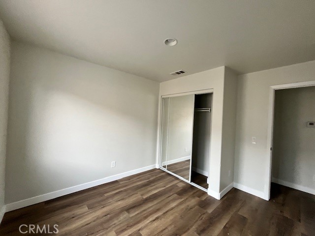 1004 South Riverside Avenue, Unit B2 Rialto, CA 92376 - Photo 9 of 14 a view of an empty room with wooden floor