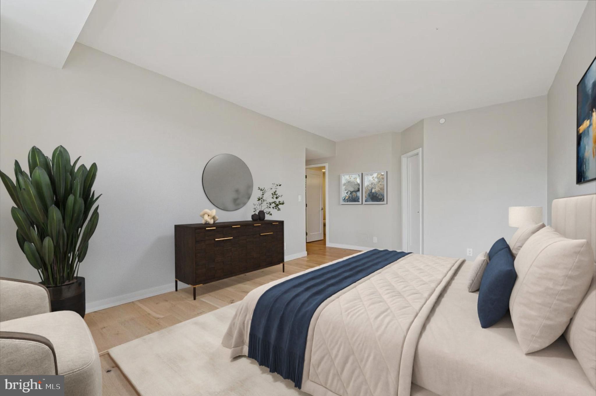 5600 Wisconsin Avenue, Unit 705 Chevy Chase, MD 20815 - Photo 24 of 62 a bedroom with a bed and a potted plant