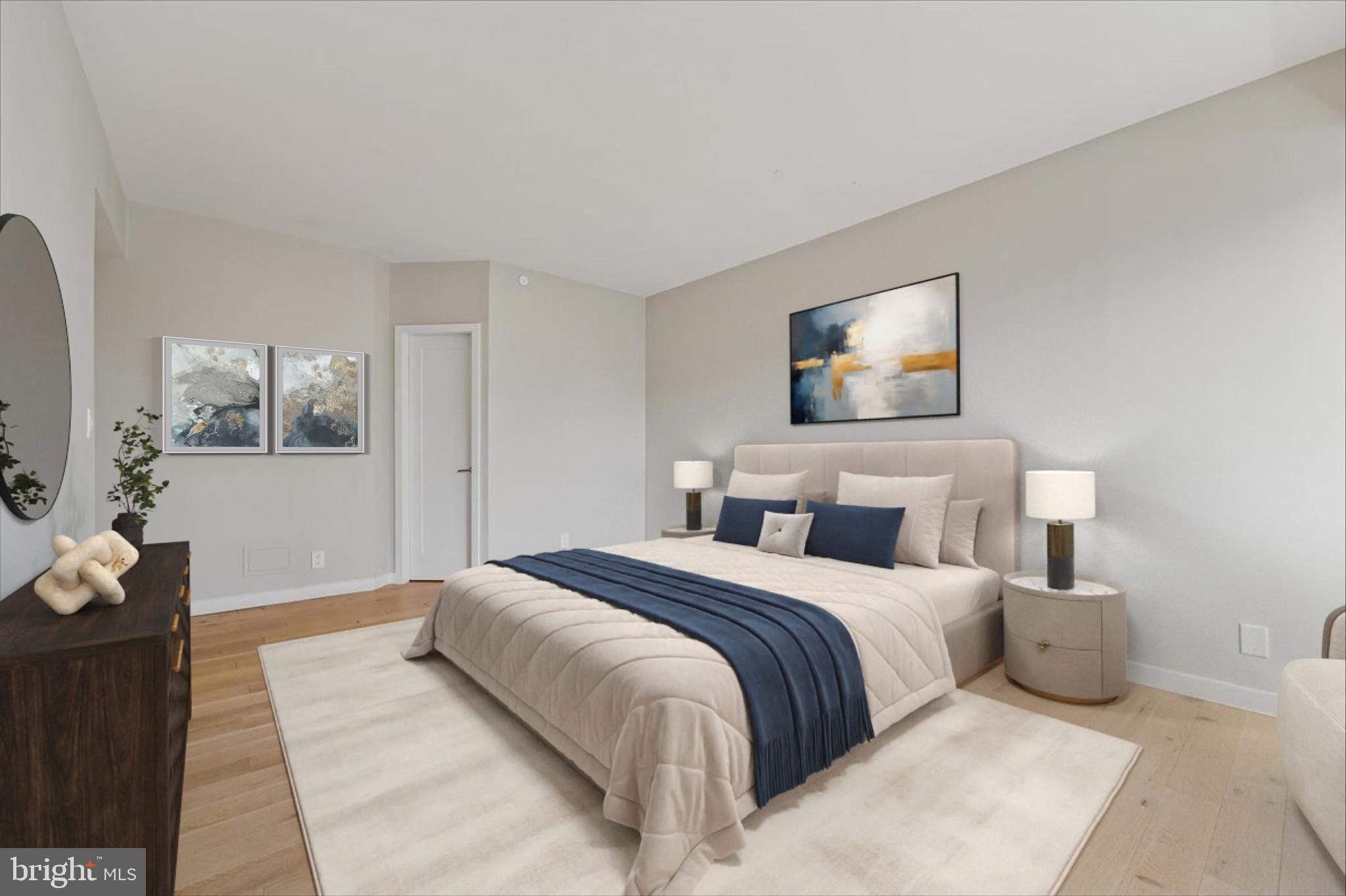 5600 Wisconsin Avenue, Unit 705 Chevy Chase, MD 20815 - Photo 26 of 62 a bedroom with a large bed and a painting on the wall