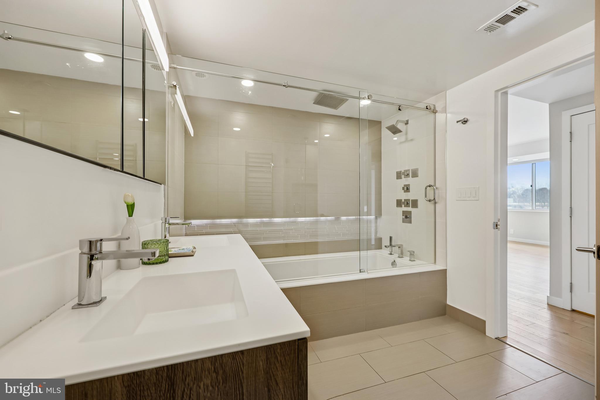 5600 Wisconsin Avenue, Unit 705 Chevy Chase, MD 20815 - Photo 27 of 62 a bathroom with a tub sink and a mirror