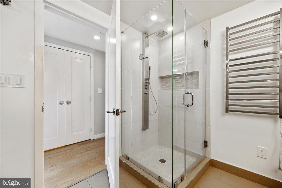 5600 Wisconsin Avenue, Unit 705 Chevy Chase, MD 20815 - Photo 29 of 62 a bathroom with a glass shower door