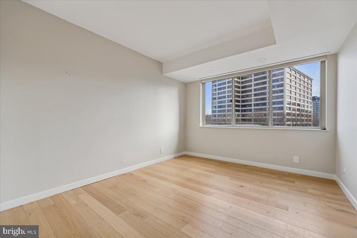 5600 Wisconsin Avenue, Unit 705 Chevy Chase, MD 20815 - Photo 33 of 62 a view of an empty room with wooden floor and a window