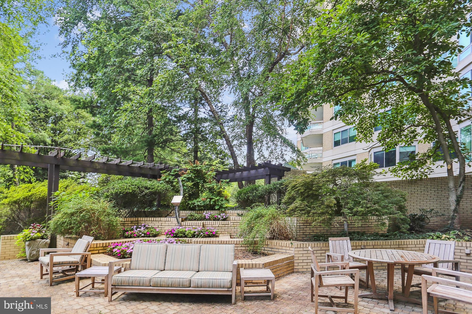 5600 Wisconsin Avenue, Unit 705 Chevy Chase, MD 20815 - Photo 45 of 62 a patio with table and chairs and potted plants