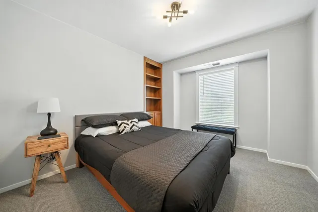 a bedroom with a bed and a chair