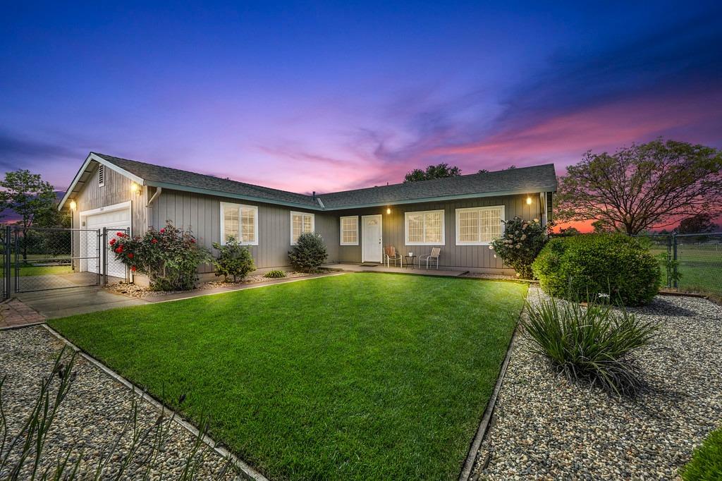 a front view of a house with garden