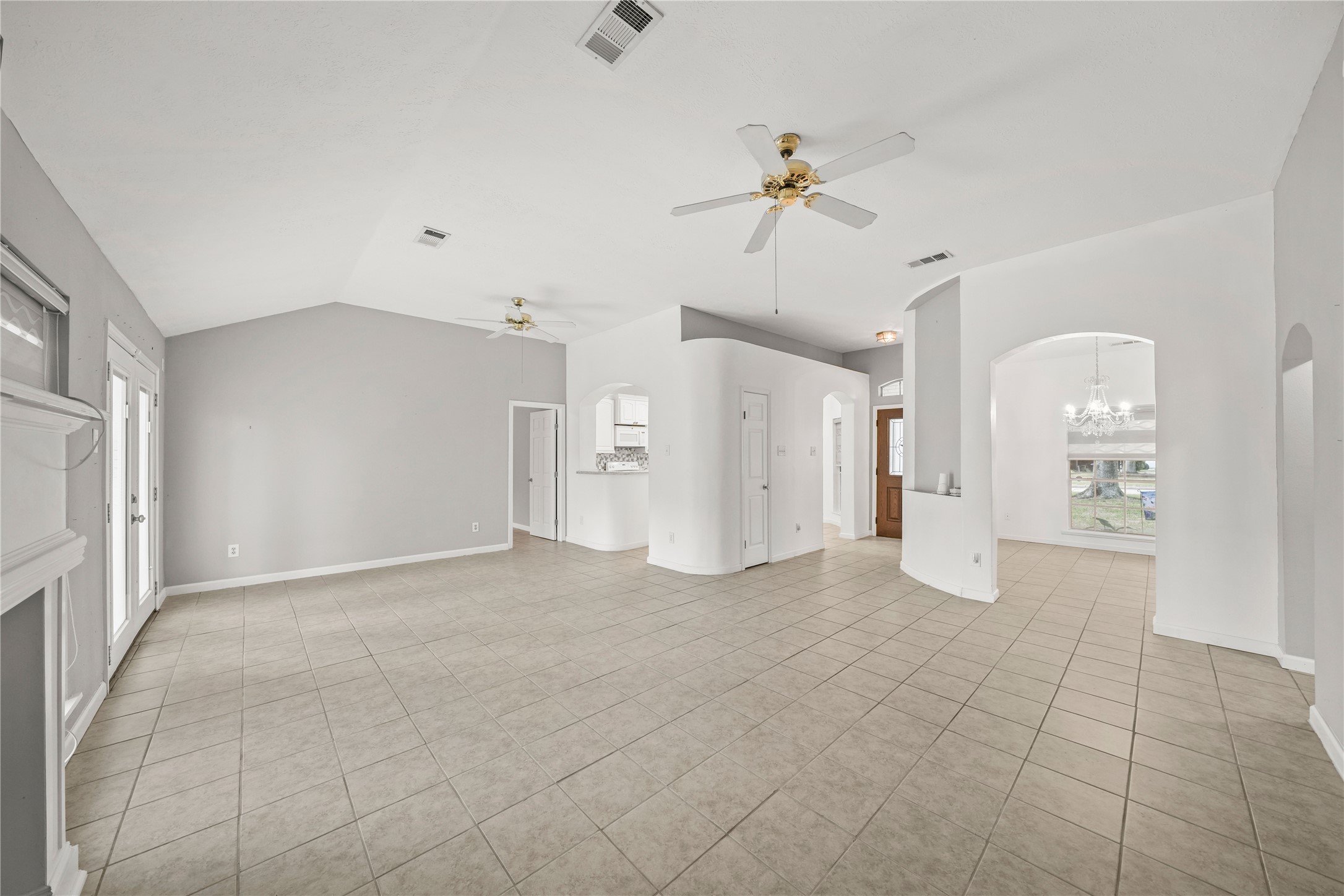 8134 Blue Jay Street Baytown, TX 77523 - Photo 12 of 31 This home features a spacious, light-filled interior designed for comfort and openness. Expansive windows allow natural light to pour in while offering relaxing views of the backyard, perfect for everyday living and entertaining.