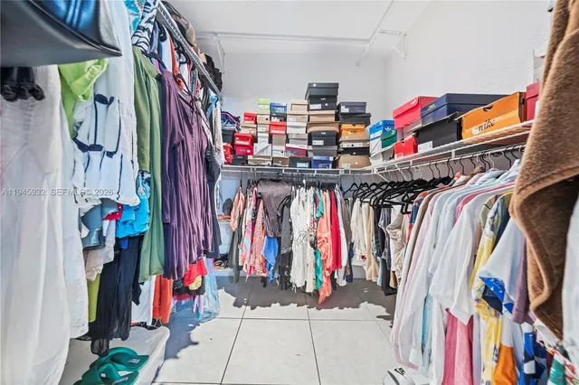 a view of walk in closet with clothes