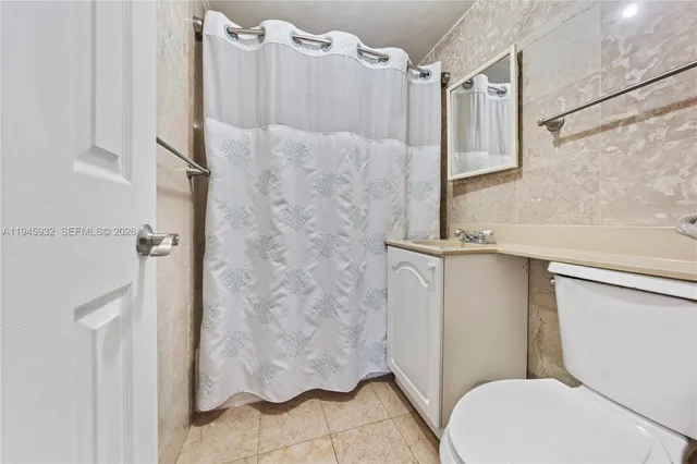 a bathroom with a toilet and shower