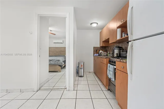 a kitchen with stainless steel appliances granite countertop a refrigerator and a stove