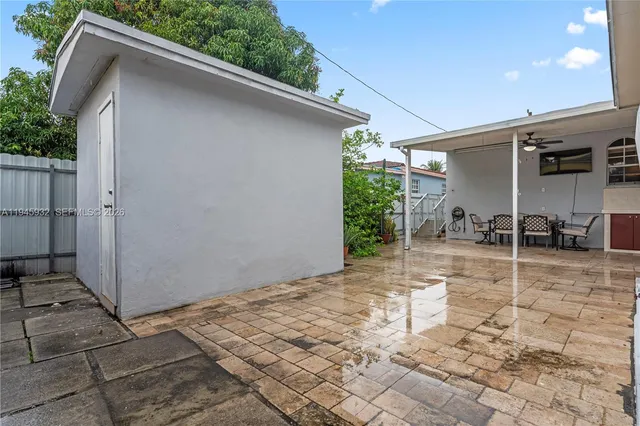 a backyard of a house with table and chairs
