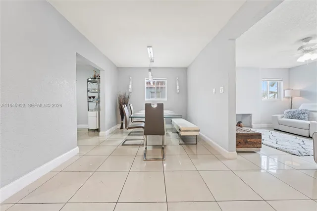 a living room with furniture and a view of dining room