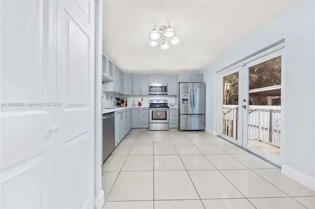 a kitchen with stainless steel appliances a refrigerator and a stove top oven