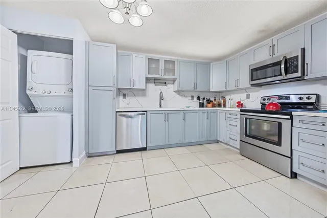 a kitchen with stainless steel appliances granite countertop a sink and a stove