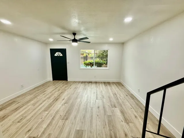 wooden floor in an empty room with a window