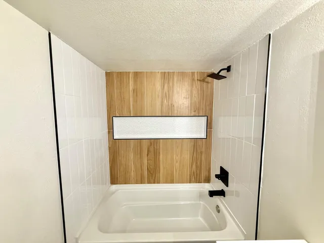 a bathroom with a tub and a shower