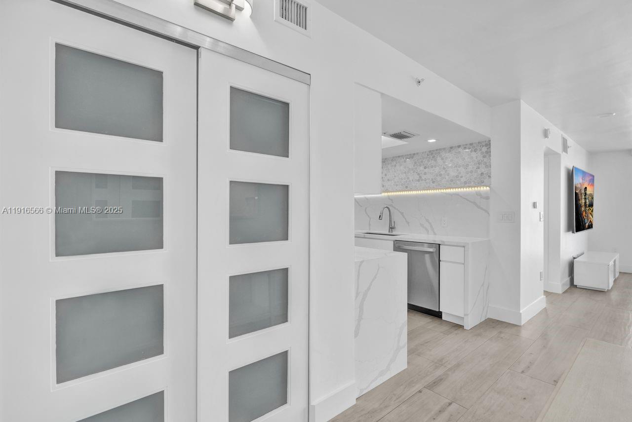 90 Alton Road, Unit 1907 Miami Beach, FL 33139 - Photo 35 of 45 a view of entryway with furniture and wooden floor