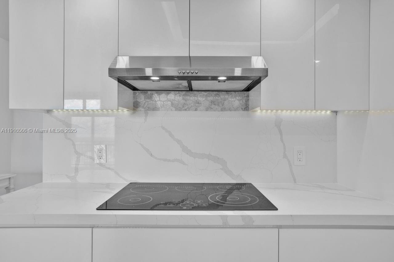 90 Alton Road, Unit 1907 Miami Beach, FL 33139 - Photo 9 of 45 a bathroom with a sink and mirror