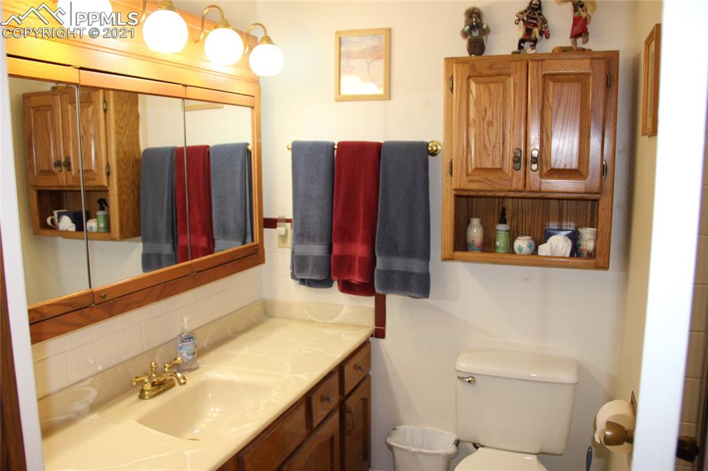 33375 Fogarty Road Calhan, CO 80808 - Photo 18 of 50 a bathroom with a sink mirror vanity and toilet