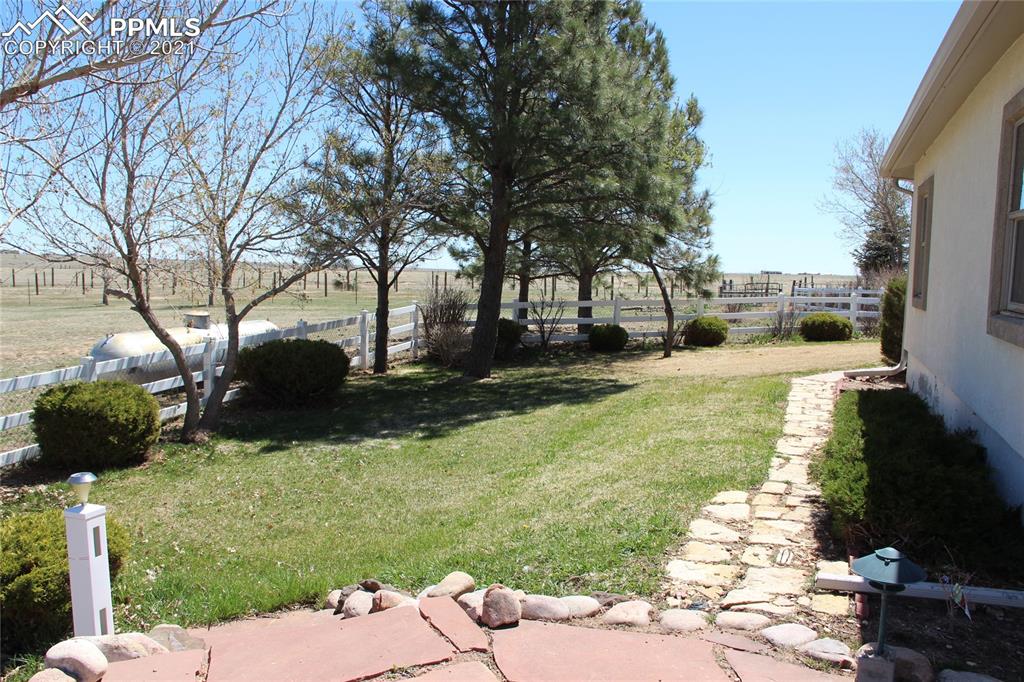33375 Fogarty Road Calhan, CO 80808 - Photo 45 of 50 a view of a garden with a bench