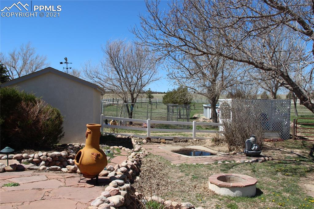 33375 Fogarty Road Calhan, CO 80808 - Photo 47 of 50 a backyard of a house with fire pit and outdoor seating
