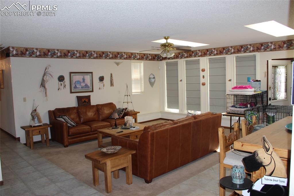 33375 Fogarty Road Calhan, CO 80808 - Photo 7 of 50 a living room with furniture and a chandelier