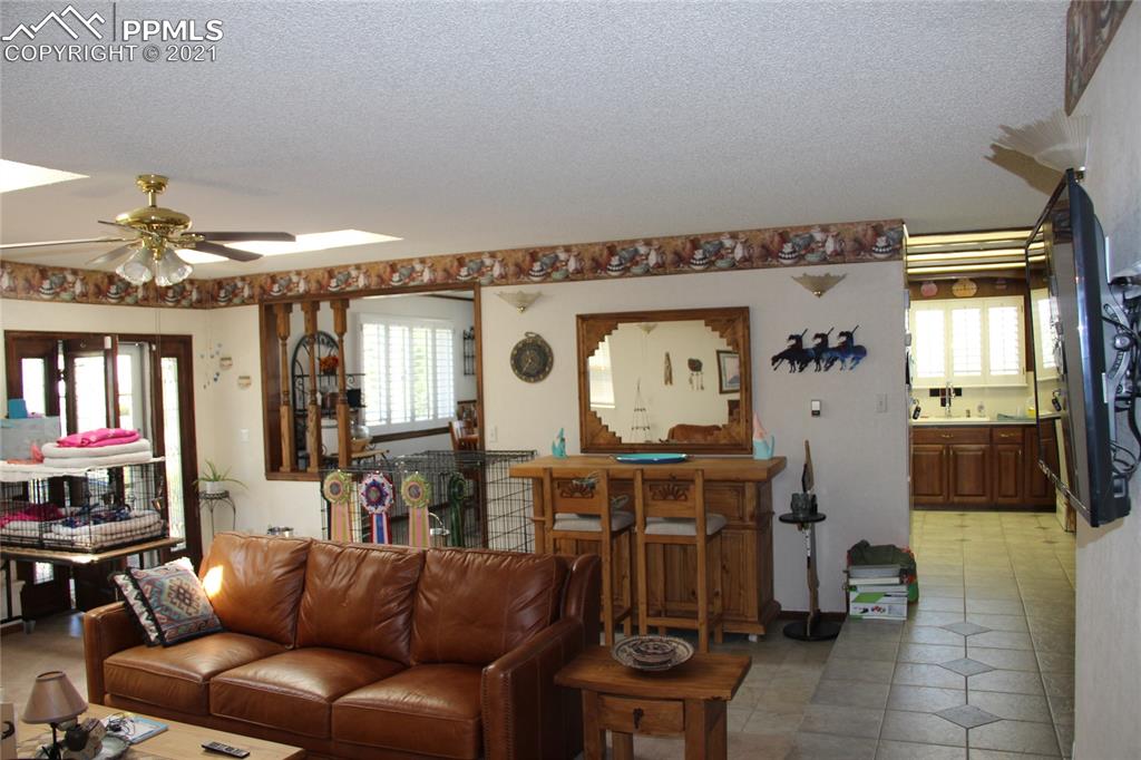 33375 Fogarty Road Calhan, CO 80808 - Photo 8 of 50 a living room with furniture and a flat screen tv