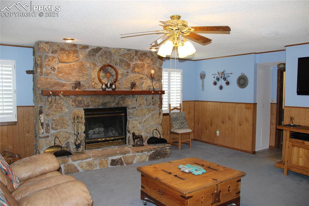 33375 Fogarty Road Calhan, CO 80808 - Photo 10 of 50 a living room with furniture and a fireplace