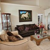 a living room with furniture and flowers
