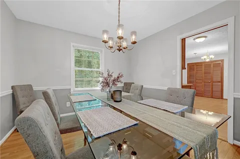 a view of a dining room with furniture and a chandelier