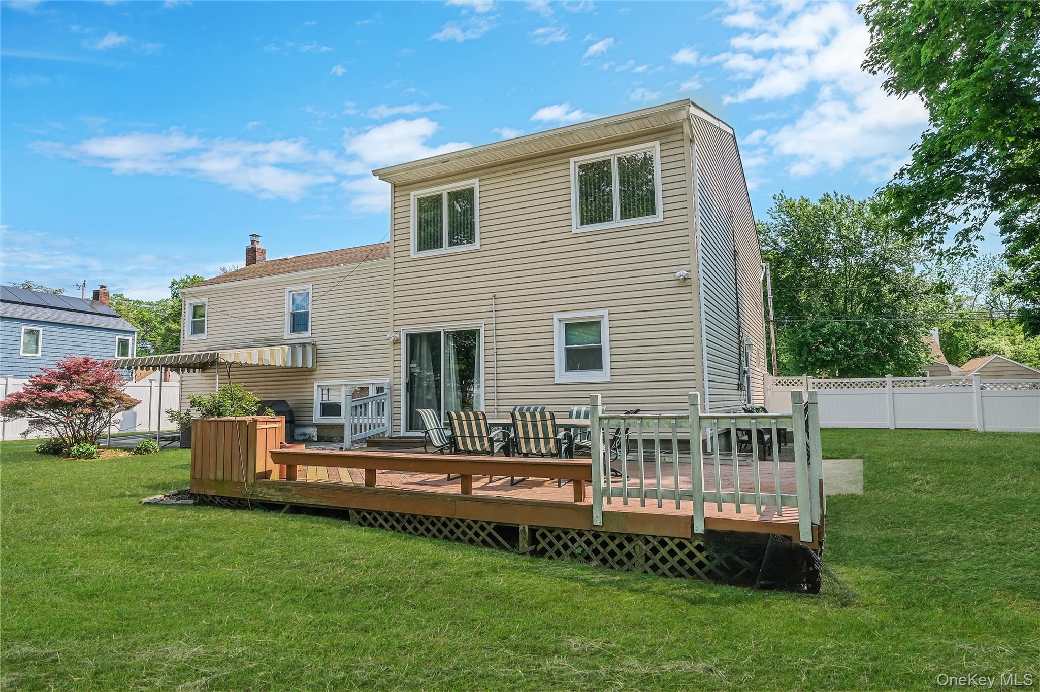 59 Maybrook Road North Babylon, NY 11703 - Photo 38 of 43 a backyard of a house with a garden and barbeque oven