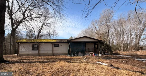 a view of a house with snow on the road