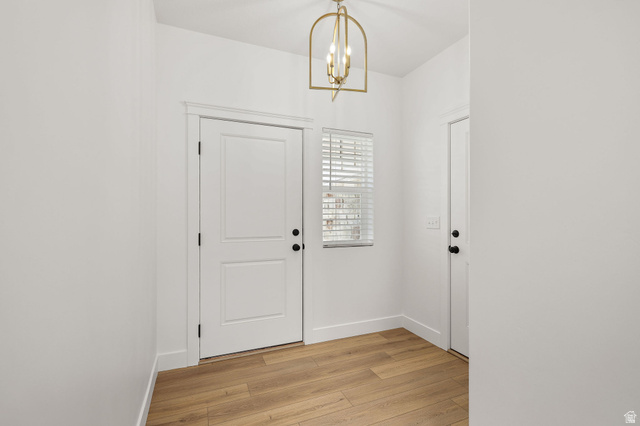 1661 West Ross Road Syracuse, UT 84075 - Photo 4 of 28 Entryway featuring light wood-style floors and hanging lights