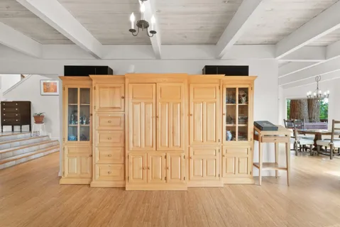 a dining room with furniture a chandelier and wooden floor