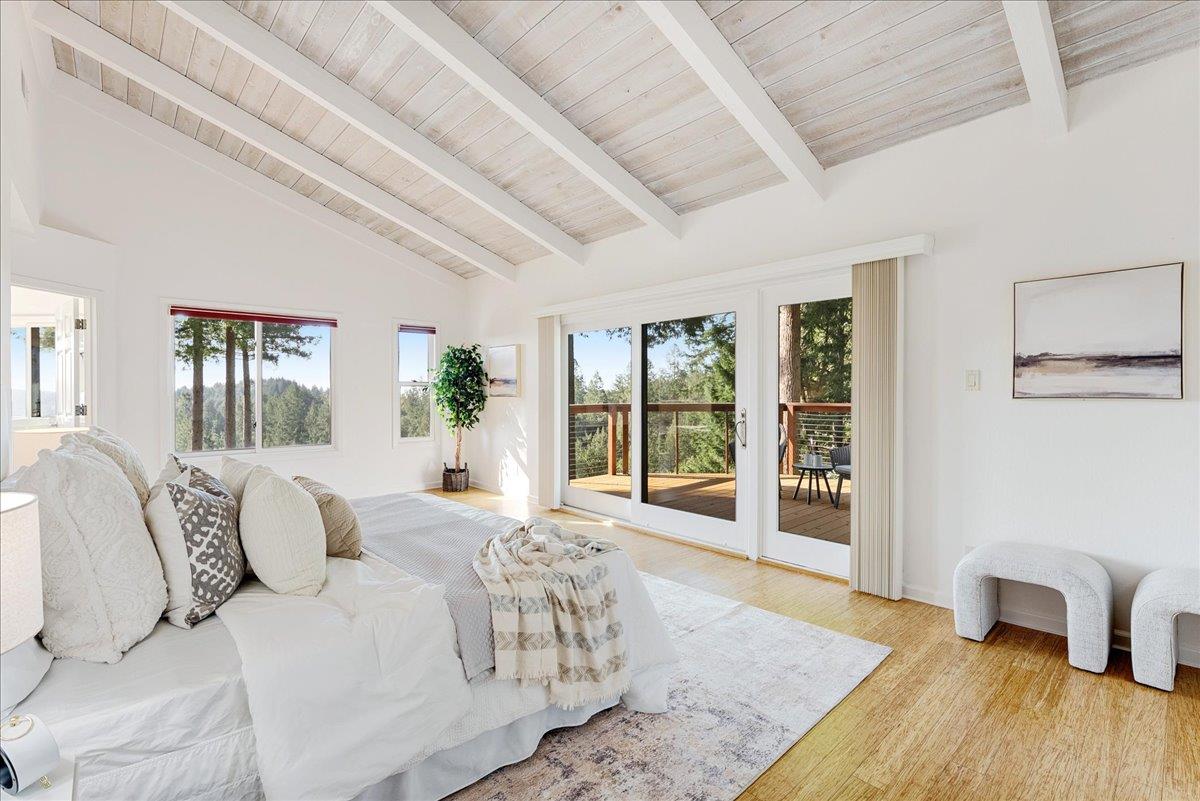480 Quail Ridge Road Scotts Valley, CA 95066 - Photo 29 of 69 a spacious bedroom with a bed a table and glass door