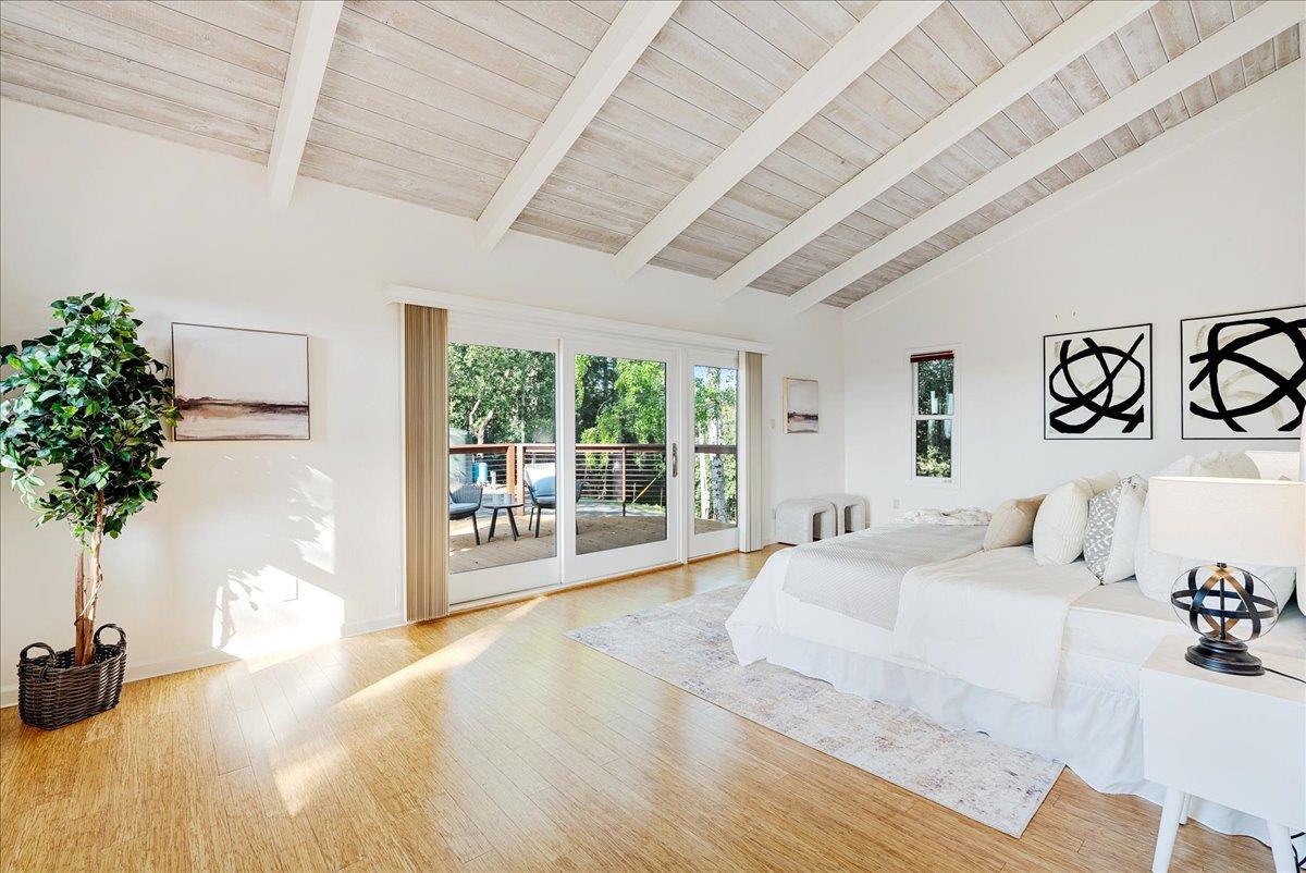480 Quail Ridge Road Scotts Valley, CA 95066 - Photo 32 of 69 a spacious bedroom with a large bed and a potted plant on the dresser