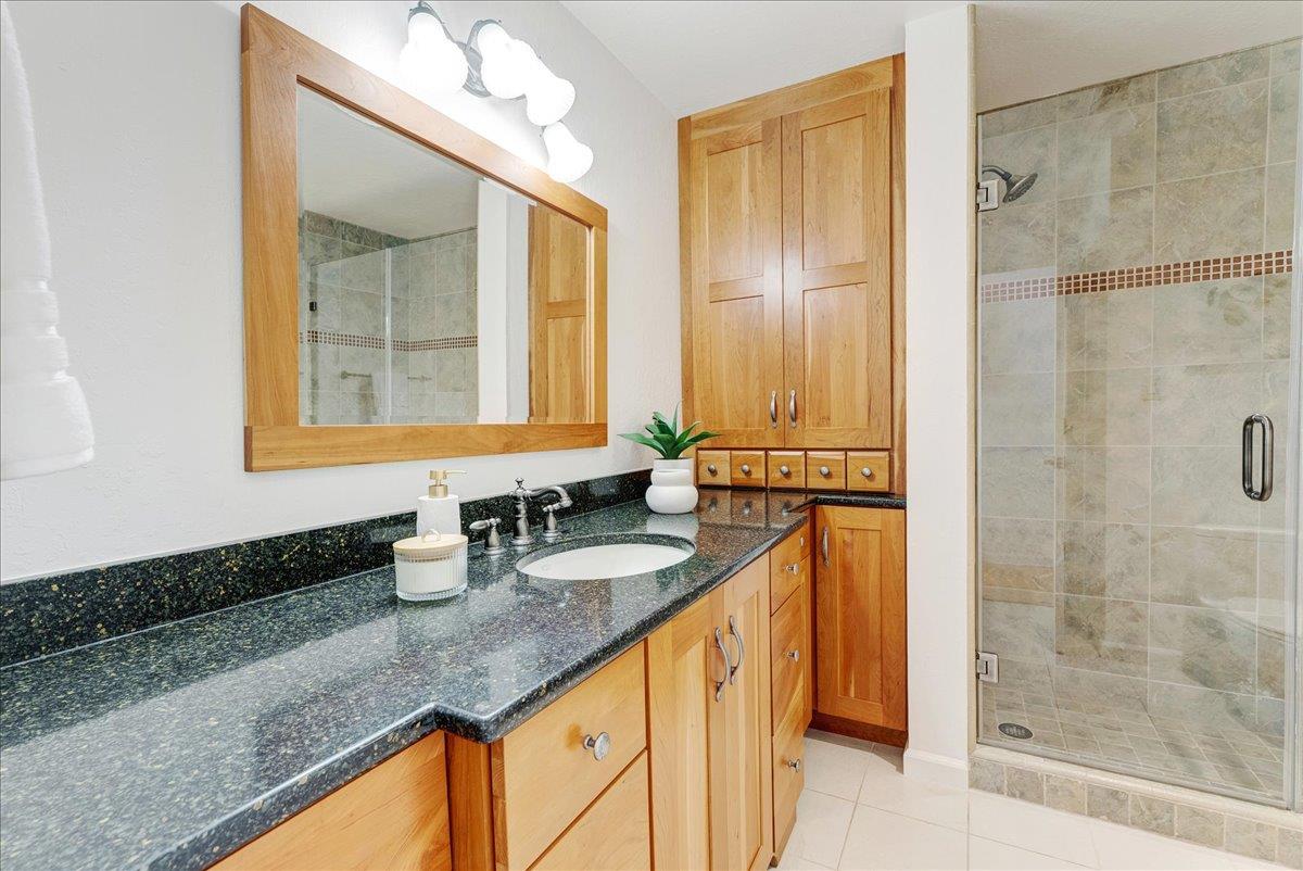 480 Quail Ridge Road Scotts Valley, CA 95066 - Photo 38 of 69 a bathroom with a granite countertop sink a mirror and shower