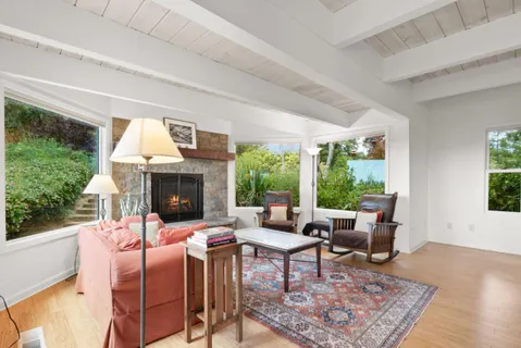 a view of a dining room with furniture large windows and wooden floor