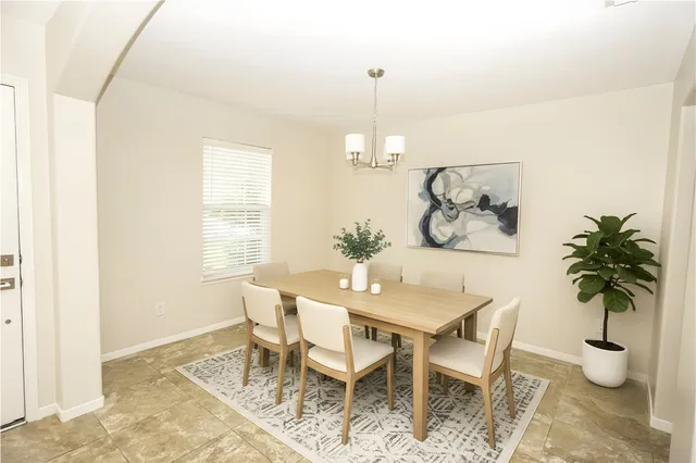a view of a dining room with furniture and a potted plant