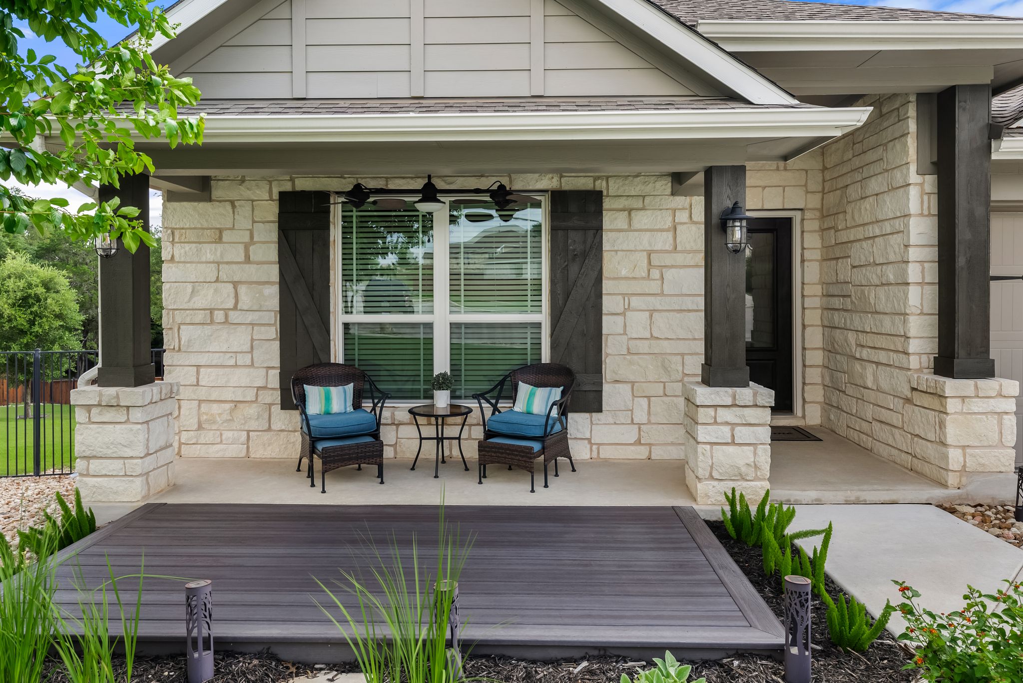 300 Prato Place Georgetown, TX 78628 - Photo 4 of 40 A welcoming stone facade with a covered porch and outdoor seating offers pleasant curb appeal.