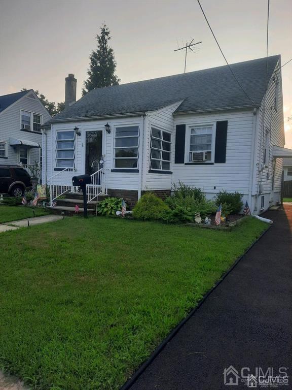 15 State Street Carteret, NJ 07008 - Photo 1 of 5 a front view of a house with a garden and yard