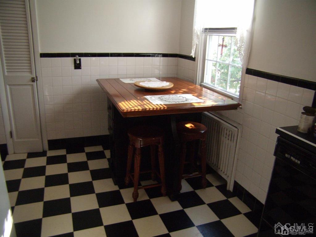 15 State Street Carteret, NJ 07008 - Photo 3 of 5 a room with a black white checkered floor and a black white checkered floor