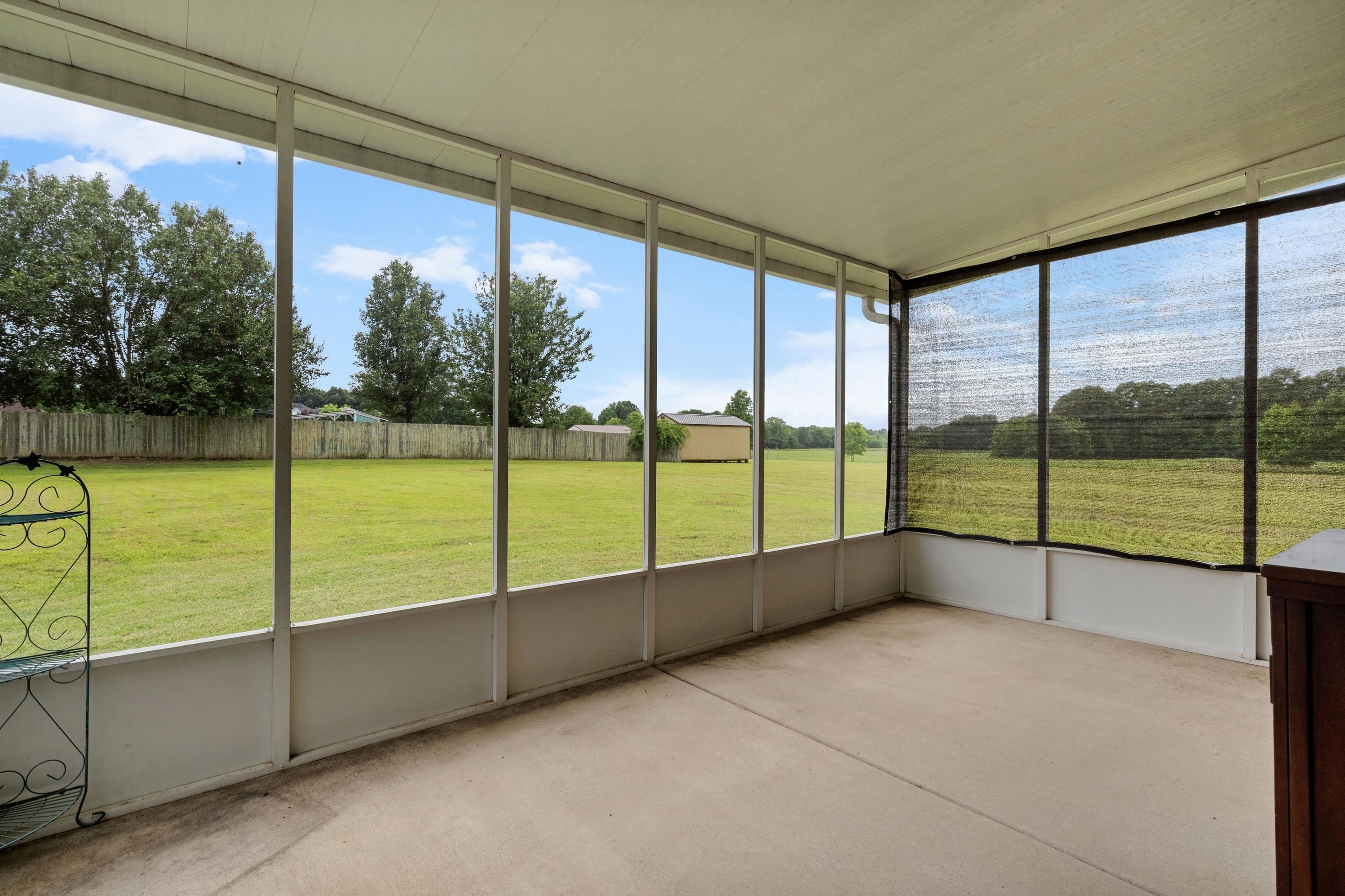 7757 Brunswick Road Millington, TN 38053 - Photo 31 of 40 Screened porch with a concrete floor and white framing