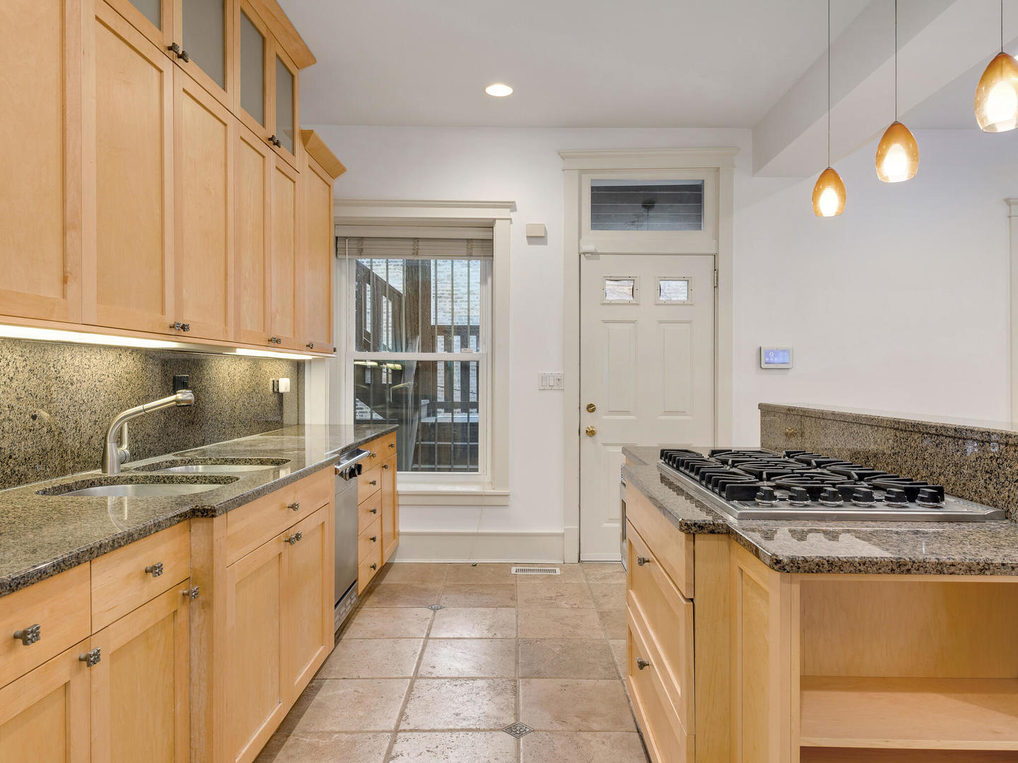 3020 North Sheridan Road, Unit 1N Chicago, IL 60657 - Photo 17 of 29 a kitchen with granite countertop a sink stove and cabinets